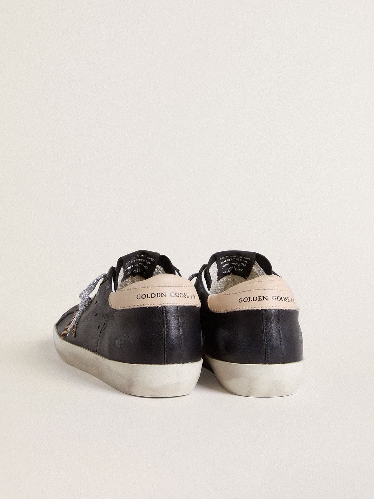Women’s Super-Star in black nappa leather with zebra-print pony skin star and beige leather heel tab | Golden Goose
