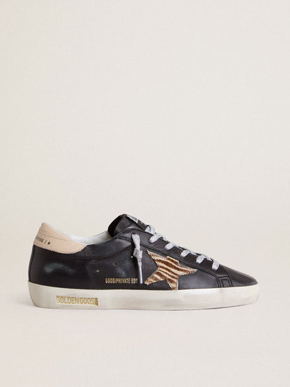 Women’s Super-Star in black nappa leather with zebra-print pony skin star and beige leather heel tab | Golden Goose
