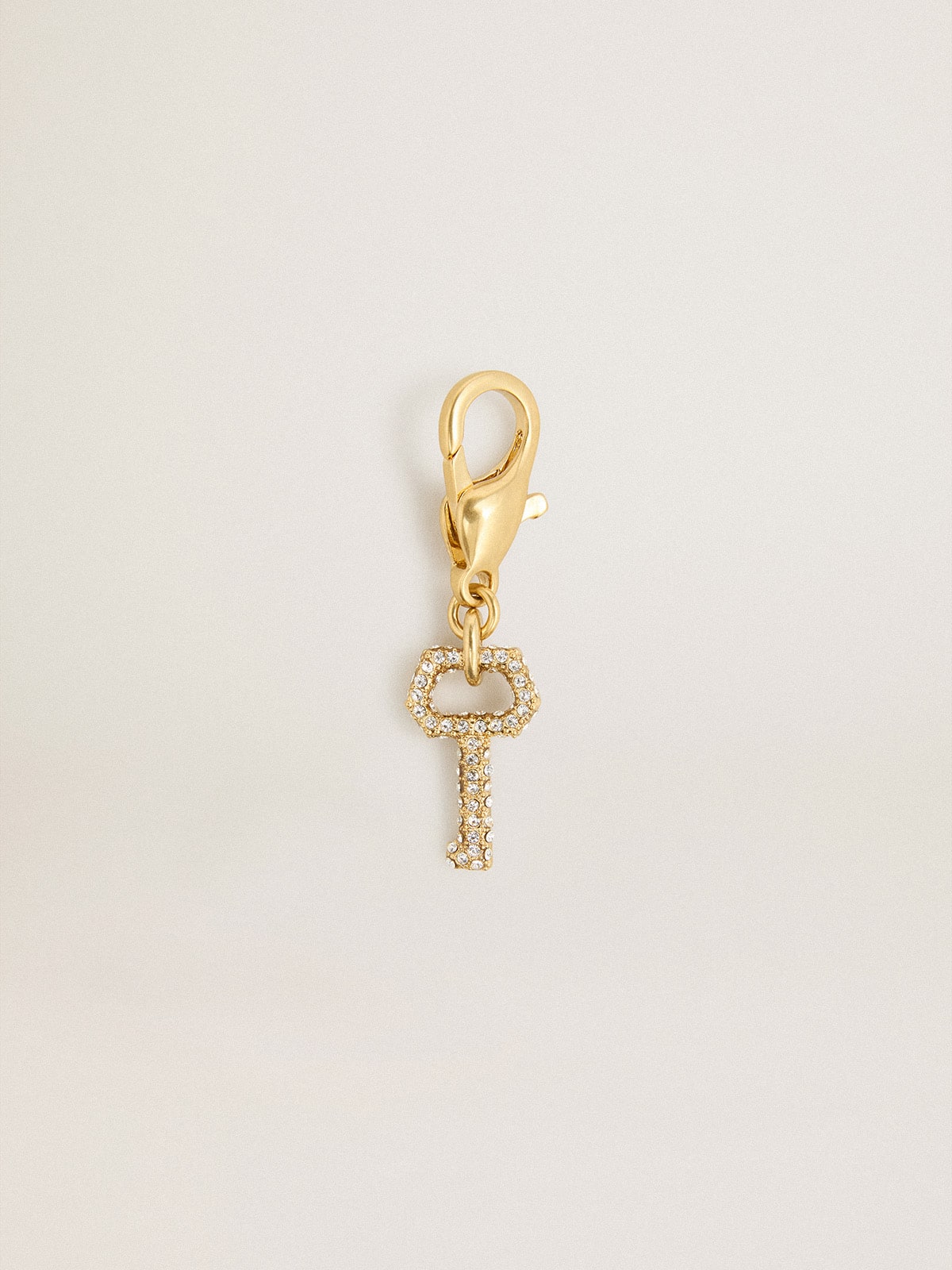 Key-shaped charm in gold-colored brass with crystals | Golden Goose