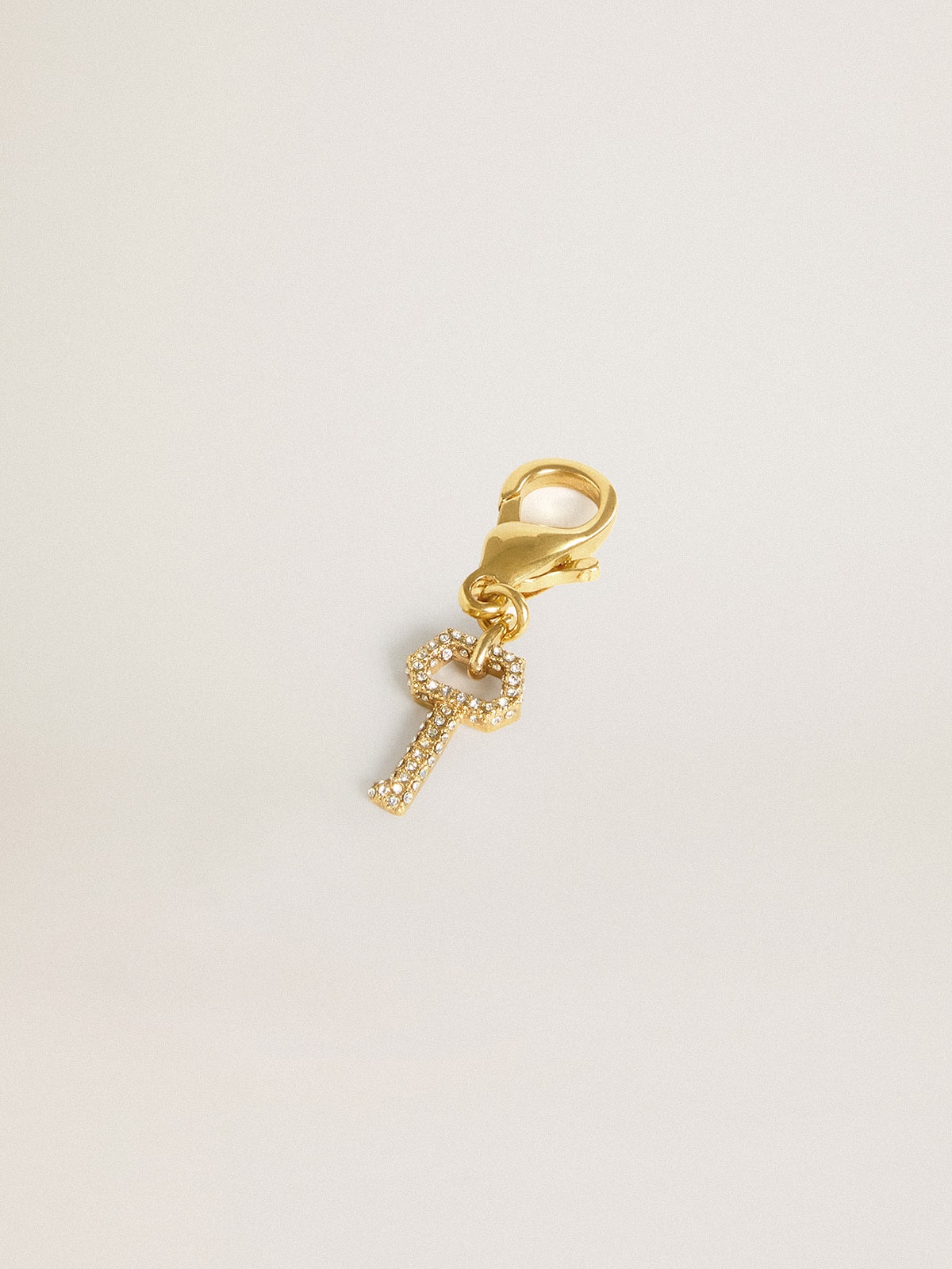 Key-shaped charm in gold-colored brass with crystals | Golden Goose