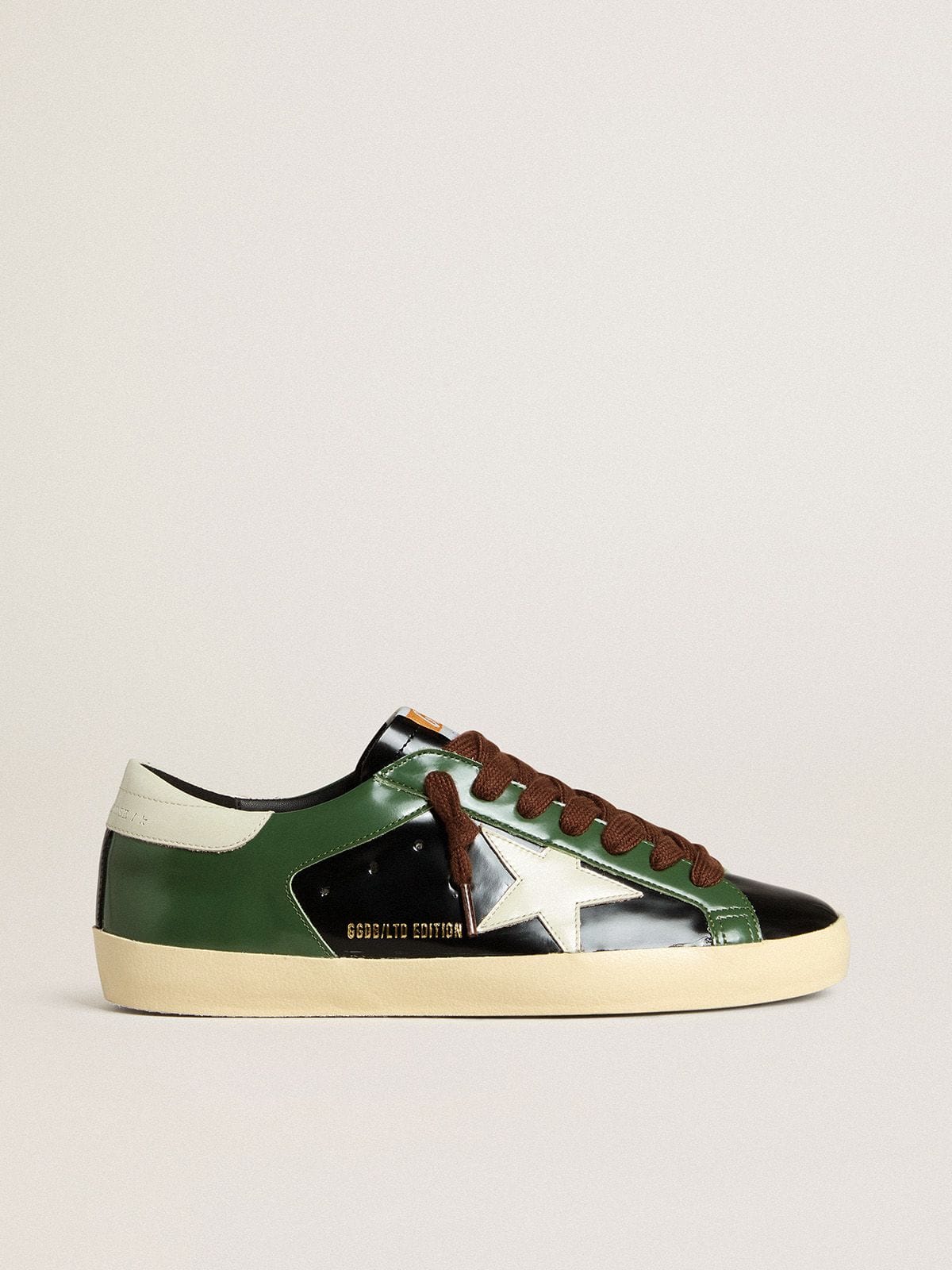 Men’s Super-Star LTD in black laminated leather with white leather star and heel tab | Golden Goose