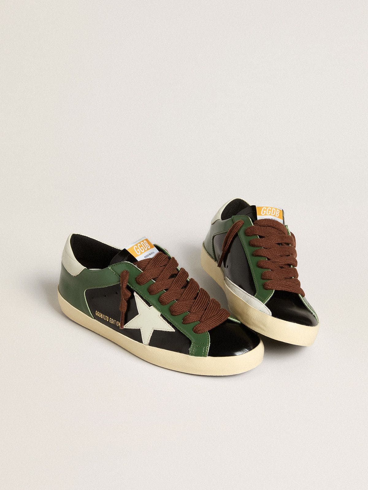 Men’s Super-Star LTD in black laminated leather with white leather star and heel tab | Golden Goose