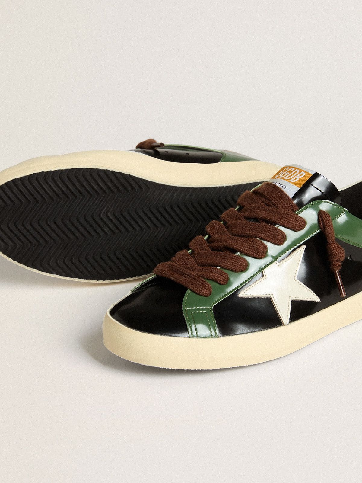 Men’s Super-Star LTD in black laminated leather with white leather star and heel tab | Golden Goose