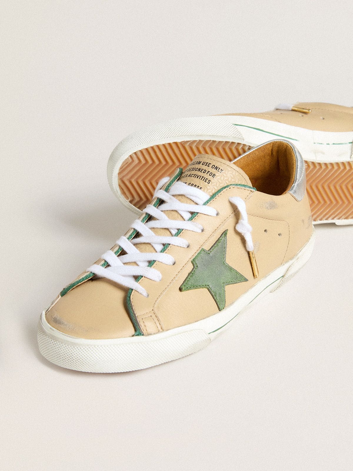 Super-Star LTD in beige leather with green suede star and silver foiled leather heel tab | Golden Goose